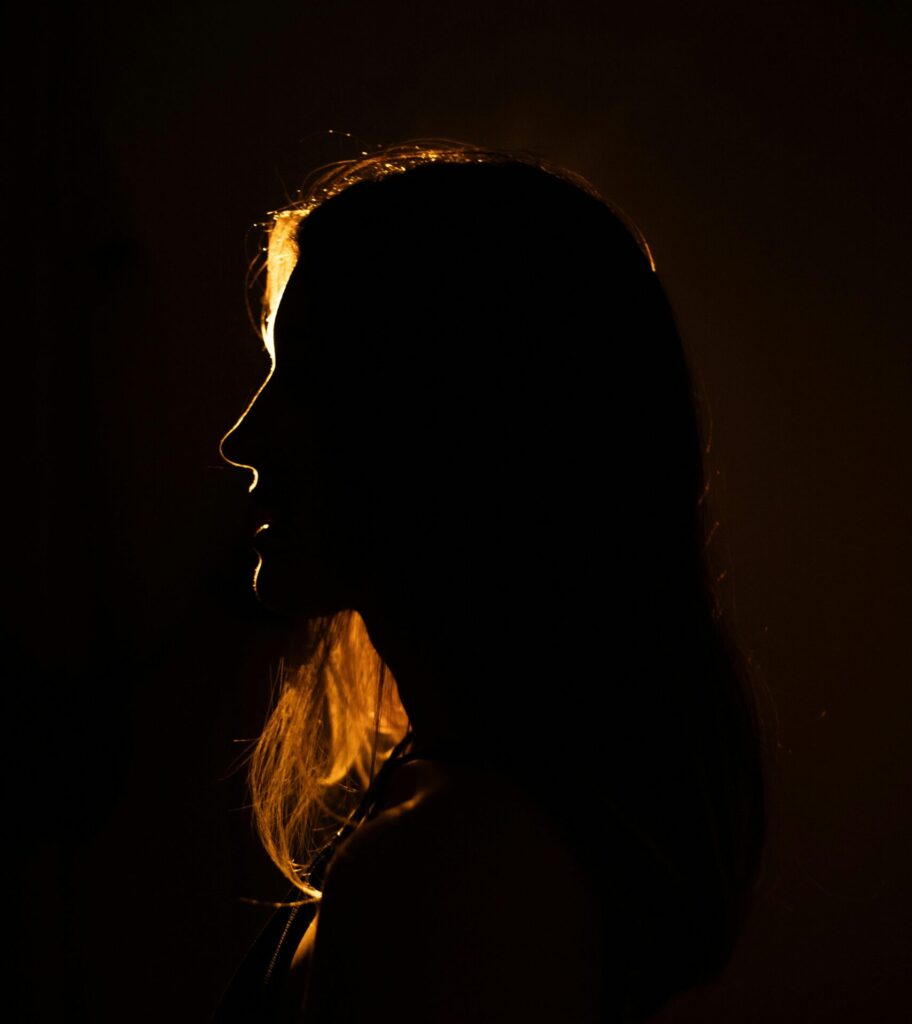 pexels-photo-27999498-27999498 Dramatic silhouette of a woman backlit, creating a captivating glow.